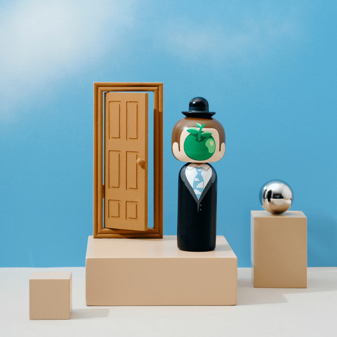 A kokeshi doll with a bowler hat and apple face stands on a beige platform with a door and a silver sphere.