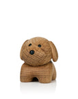 A small wooden dog figurine with a smooth finish and simple carved details.
