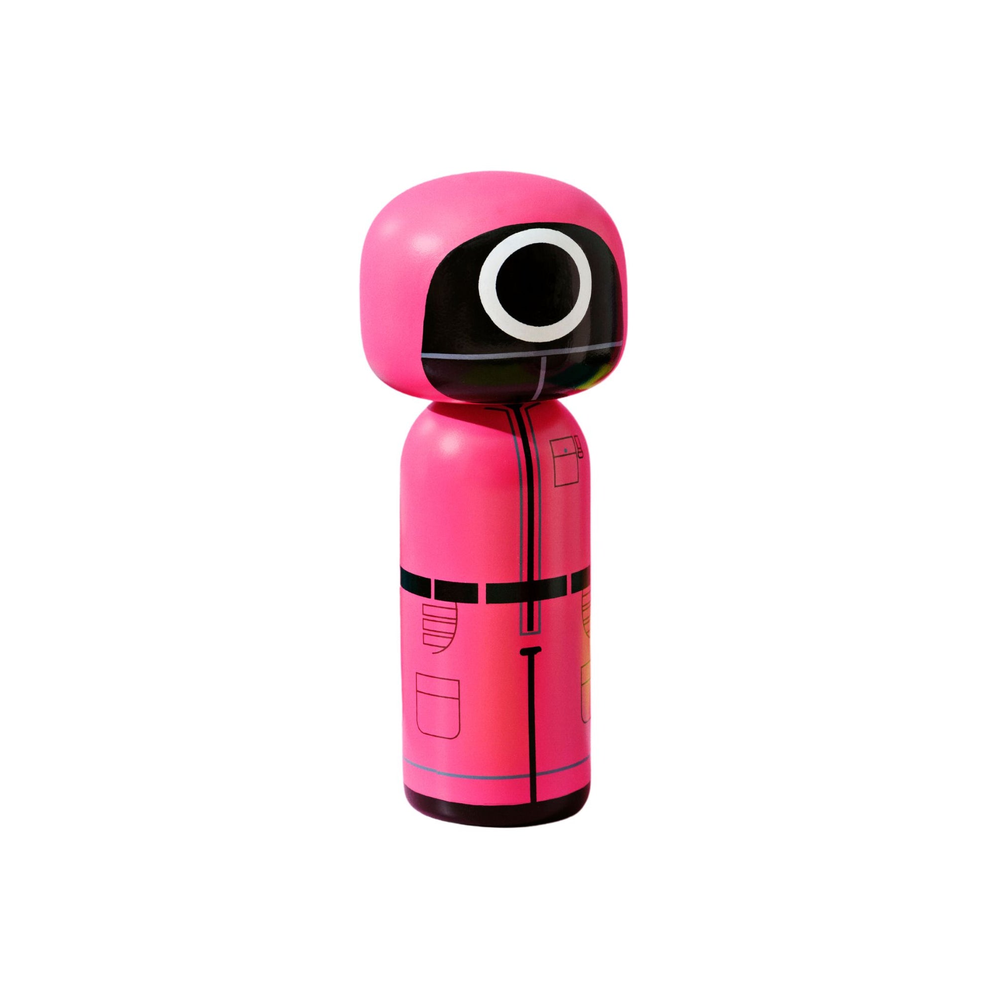 A pink kokeshi doll with a black mask and circular design on the face.