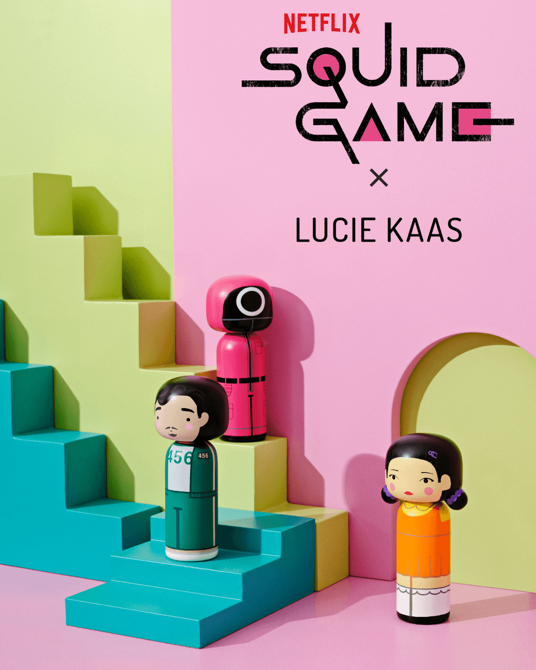 Kokeshi dolls inspired by Squid Game characters on colorful geometric steps.