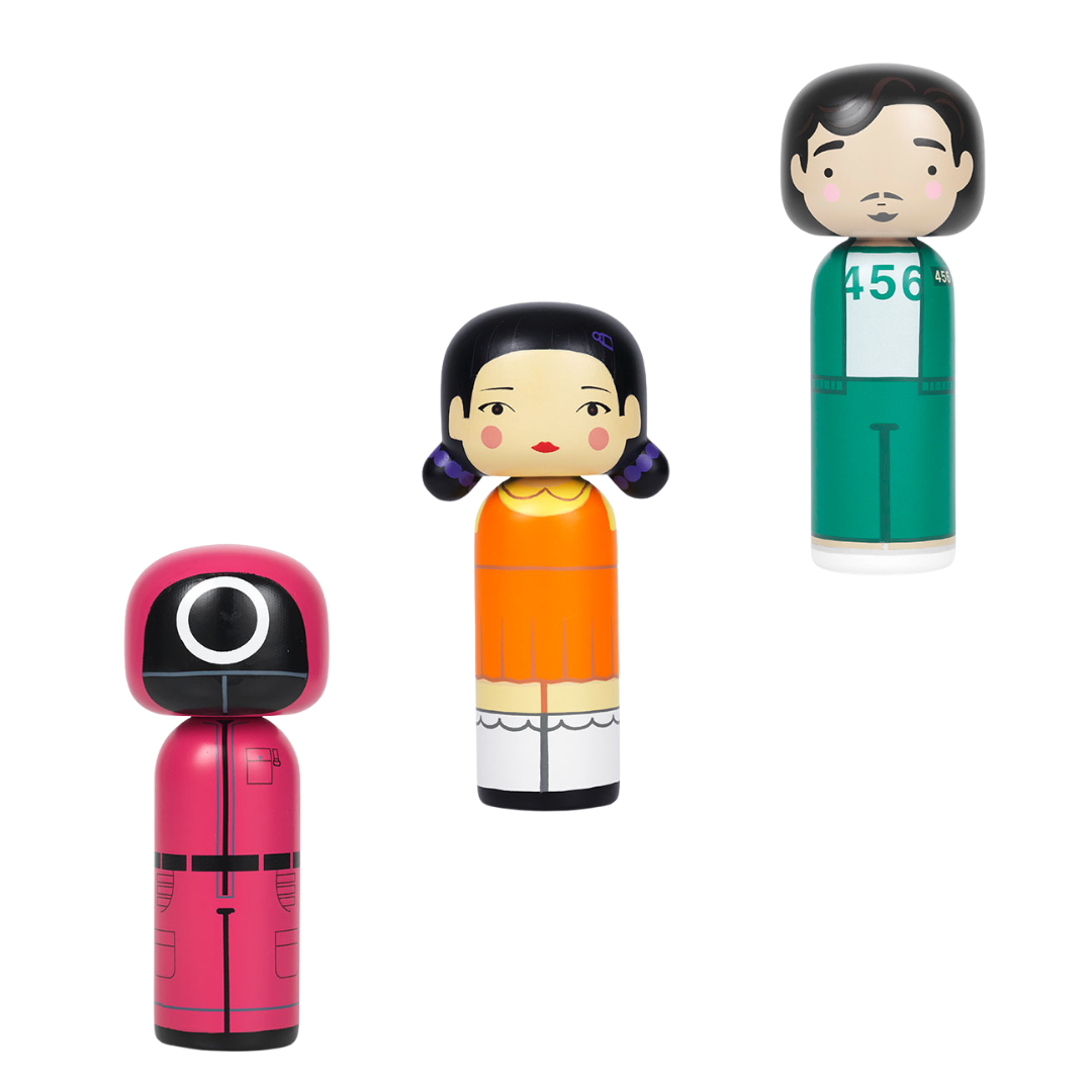 Three kokeshi dolls inspired by a popular TV series, featuring distinct costumes and facial expressions.