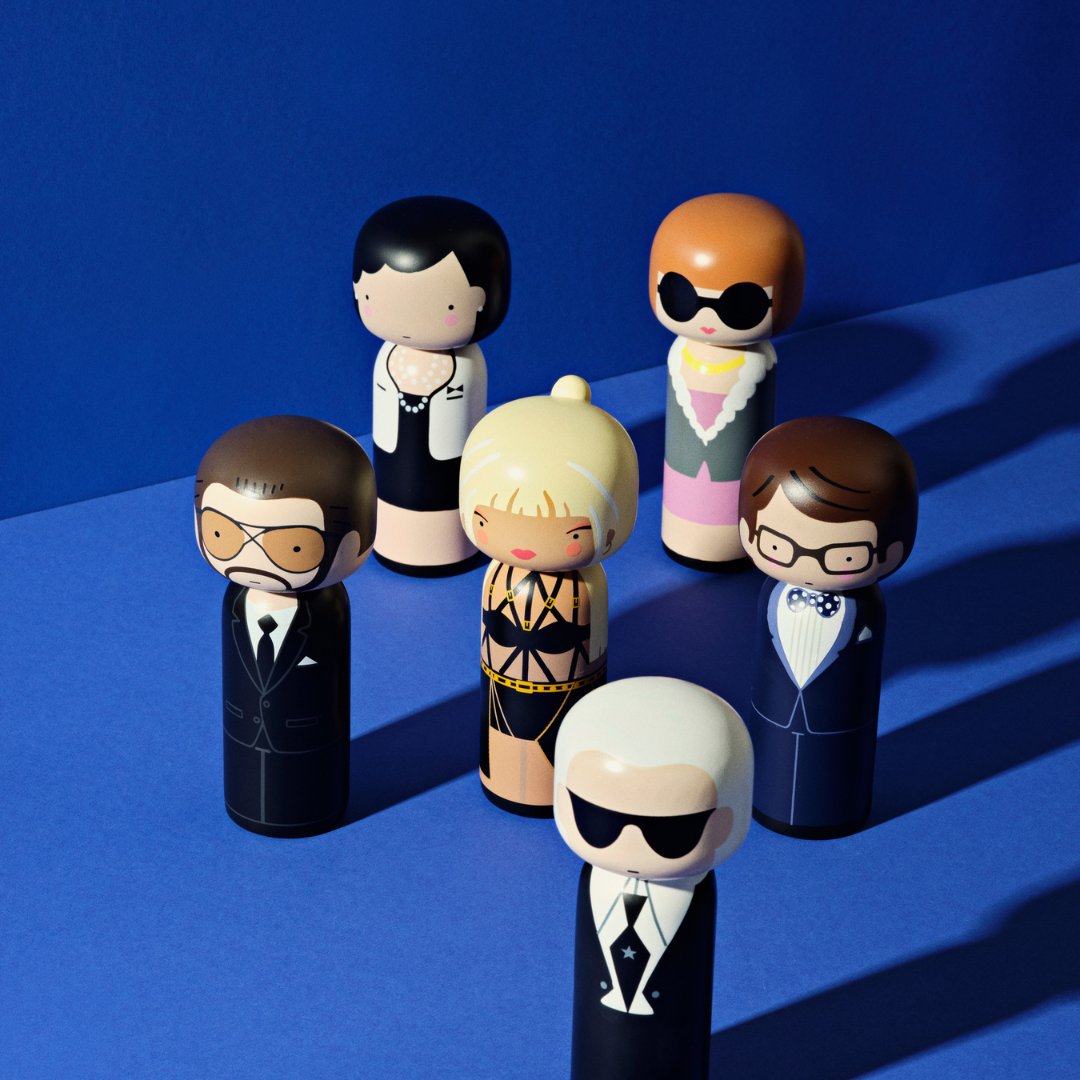 A  selection of Lucie Kaas&#39; kokeshi dolls on a dark blue background