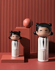Lucie Kaas' Jean Michel Basquiat Three-point-crown Kokeshi Doll in two sizes on red background
