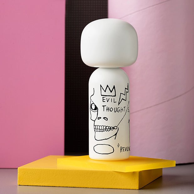 Jean-Michel Basquiat, Evil Thoughts White, Kokeshi doll on a yellow platform in a pink setting