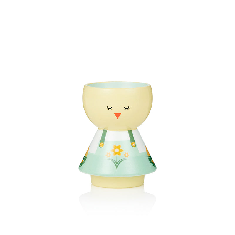Poupée kokeshi aux couleurs pastel avec une tête jaune, des yeux fermés et une robe fleurie.