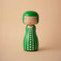 Lucie Kaas green polka-dot kokeshi doll with bob haircut and pink cheeks on beige background