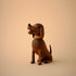 Lucie Kaas wooden dachshund figurine, smiling walnut dog with carved collar, sitting