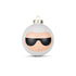 A white Christmas ornament with a minimalist face design wearing black sunglasses.