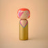 Lucie Kaas wooden kokeshi doll in gold gown, coral hair and pink lightning face paint, glam rock