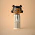 Lucie Kaas wooden kokeshi doll in gray pinstripe suit with black tie on beige background