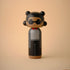 Lucie Kaas kokeshi doll wearing sunglasses, gray coat and red collar on beige background