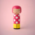 Lucie Kaas pink polka-dot kokeshi doll with yellow base, minimalist face and pearl necklace