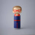 Lucie Kaas kokeshi doll with red polka-dot glasses, blue and red outfit, minimalist wooden figure