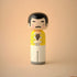 Lucie Kaas kokeshi doll inspired by an iconic rock star in a yellow jacket and white trousers