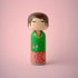 Lucie Kaas kokeshi doll with green jacket Be Kind text, mushroom motifs and red patterned base