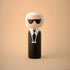 Lucie Kaas kokeshi doll with white hair, black sunglasses and tuxedo-inspired suit