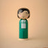 Lucie Kaas kokeshi doll of Squid Game player 456 in green tracksuit, minimalist wooden figure