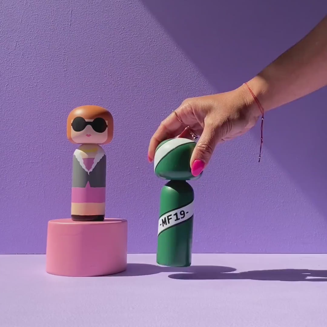 Video that shows multiple Kokeshi Dolls being swapped out on a purple background