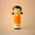 Lucie Kaas wooden kokeshi doll inspired by Squid Game girl, orange dress and pigtails