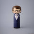 Lucie Kaas kokeshi doll in navy tuxedo with polka dot bow tie and black glasses, brown hair
