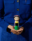 A Frida Kokeshi Doll held in two hands