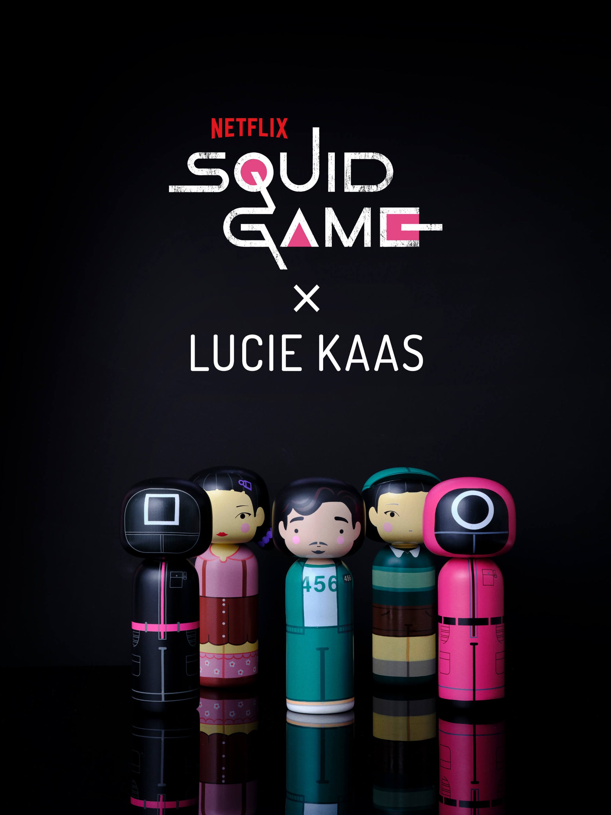 Kokeshi-Puppen, inspiriert von Squid Game , mit Lucie Kaas- und Netflix-Logos darüber.