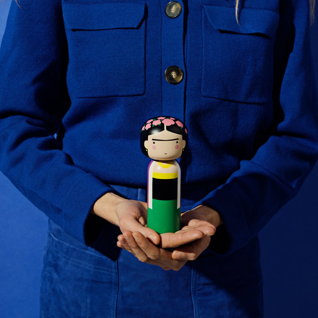 A Frida Kokeshi Doll held in two hands